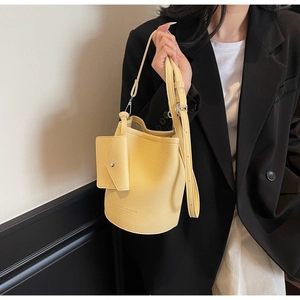 Detail of light yellow lychee pattern leather bucket bag with an envelope coin pouch