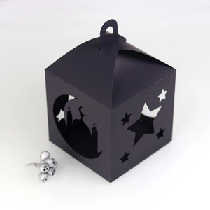Detail of black laser-cut paper lantern featuring mosque and star moon patterns