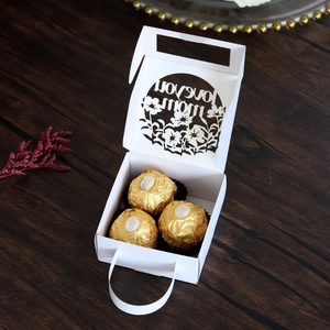 Detail of white hollow-out laser cut gift box featuring I Love You Mom text for chocolates