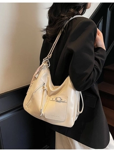 Large beige soft leather hobo tote bag with fringe detail and buckle pocket for women