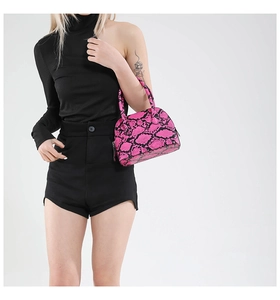 Detail of pink snakeskin shell bag featuring textured faux leather and zip closure