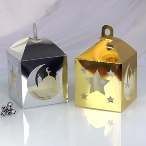 Detailed laser-cut star and moon patterns on shiny gold and silver Ramadan gift boxes