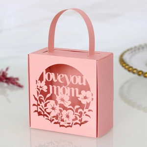 Detailed laser-cut 'Love You Mom' text and floral pattern on pink paper gift box