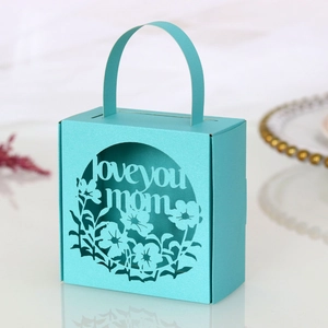 Detail of Tiffany blue gift box featuring laser-cut Love You Mom text and floral pattern