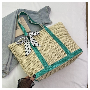 Macro view of woven straw tote bag featuring green sequins and polka dot silk scarf