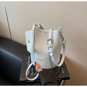 Detail of light blue lychee pattern bucket bag with silver buckle and detachable coin purse