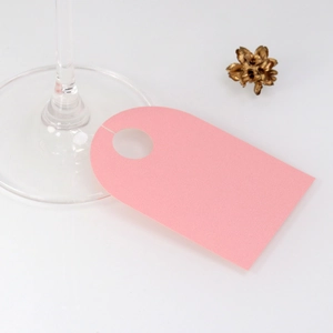 Pink paper wine glass place cards for wedding party table settings and guest names
