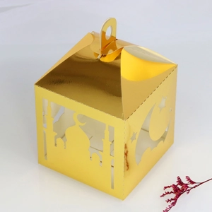 Detailed laser-cut gold Eid Mubarak gift box with mosque and moon patterns