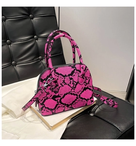 Detail of the pink snake pattern shell bag showing the glossy PU leather texture and strap