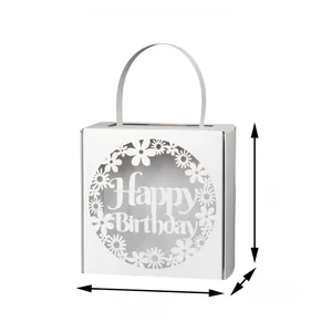 Close-up of white laser-cut Happy Birthday candy box with elegant floral hollow patterns