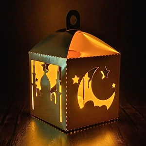Detail of laser cut mosque and crescent moon patterns on golden Ramadan lantern box