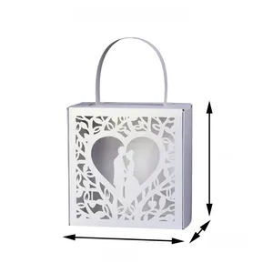 Detailed laser-cut white wedding favor box featuring romantic heart and couple silhouette