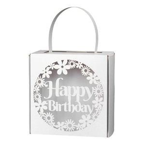 Detail of laser cut white paper gift box featuring Happy Birthday floral pattern