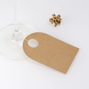 Kraft paper wine glass place cards with circular cutout for wedding party table setting