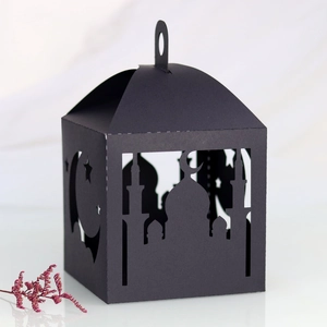 Detailed laser-cut black paper gift box with crescent moon and star patterns for Eid