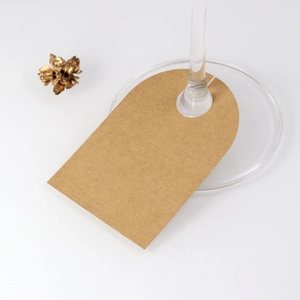 Macro detail of brown kraft paper wine glass place cards for wedding table settings