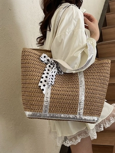Woven straw tote bag with silver sequins and black polka dot bow for summer beach