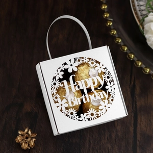 Detailed laser-cut white gift box with Happy Birthday lettering on a dark wood background