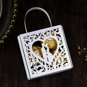 Detail of laser-cut wedding candy box with heart silhouette on premium white cardstock