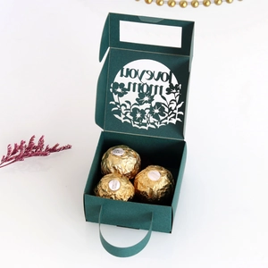 Detail of dark green Mother's Day gift box with Love You Mom laser-cut design