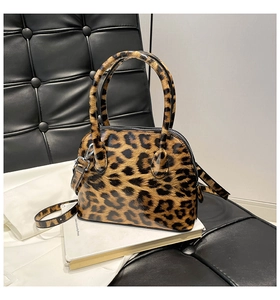 Close-up of leopard print shell bag with silver hardware on a lifestyle background
