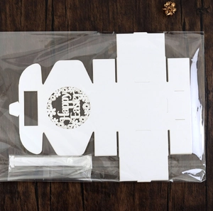 Flat lay of Happy Easter laser-cut white cardstock gift box template with floral detail