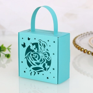 Detail of laser-cut butterfly and rose patterns on a tiffany blue wedding favor gift box