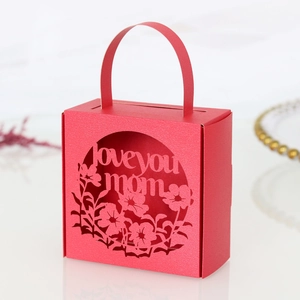 Detail of red laser-cut candy box with 'love you mom' floral engraving for Mother's Day