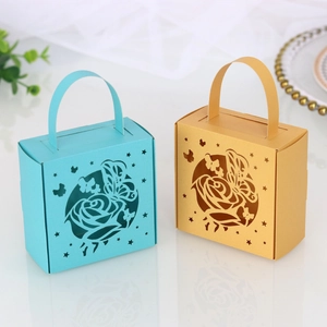 Detail view of laser-cut butterfly and rose patterns on blue and gold gift boxes