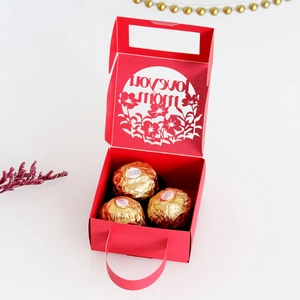 Detail of red laser-cut gift box featuring Love You Mom text with floral patterns