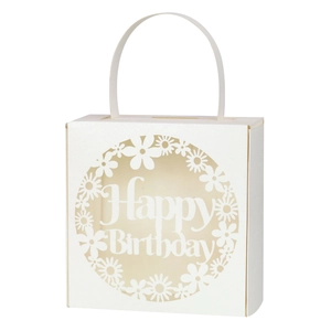 Detail of laser-cut flower patterns and Happy Birthday lettering on white gift box