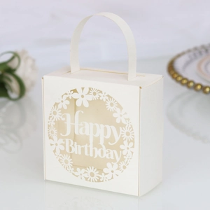 Detail of warm white laser-cut paper gift box featuring Happy Birthday cutout design