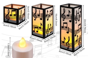 Three sizes of black laser-cut music lanterns with musical notes and LED candle