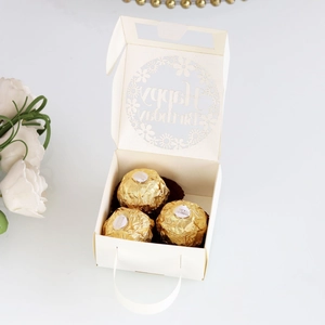 Detail of cream white Happy Birthday laser cut candy box with elegant floral hollow lid