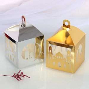 Detail of laser-cut gold and silver Ramadan lanterns with mosque and crescent moon motifs