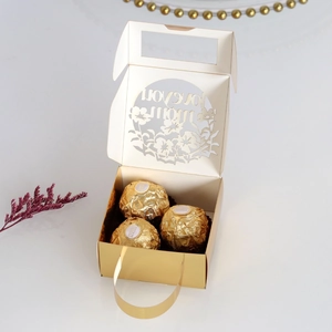 Close-up of laser-cut Love You Mom hollow gift box with three chocolates inside