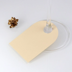 Detail of cream arched place cards for wine glass base used for wedding banquet events