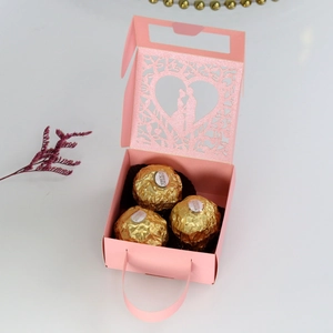 Inside view of pink laser-cut wedding favor box showing capacity for three chocolates
