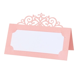 Pink laser-cut table place card with pearl finish and hollow floral pattern design