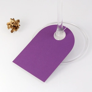 Detail of purple kraft paper wine glass name cards for wedding place settings