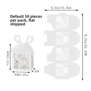 Detailed view of laser-cut white favor boxes with tropical leaf patterns and dimensions