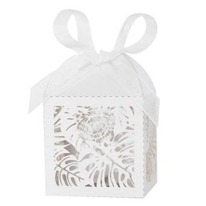 Detailed laser cut tropical leaf pattern on white wedding favor box with organza ribbon