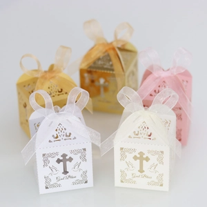 Detail of laser-cut cross gift boxes with God Bless gold foil and ribbon in multi colors