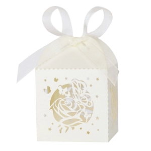 Detail of cream laser cut candy box with butterfly motifs and white chiffon ribbon