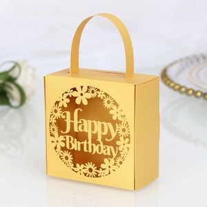 Detail of laser-cut Happy Birthday candy box in champagne gold pearl paper with handle
