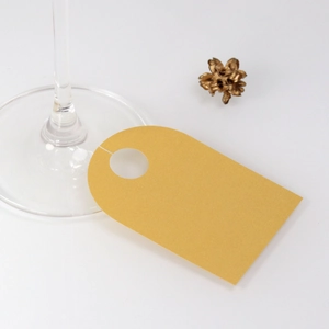 Elegant gold wine glass place card with circular cutout for wedding table settings