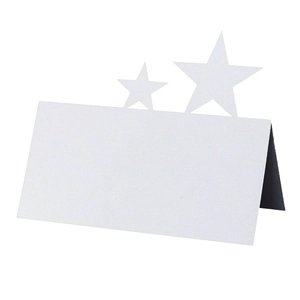 Macro shot of white pearlescent tent card with hollowed star design for weddings