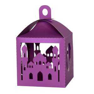 Close-up of purple laser-cut paper gift box featuring mosque silhouettes for Ramadan