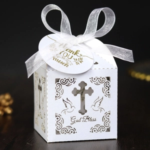 White laser-cut cross gift box with God Bless text and white ribbon bow for parties