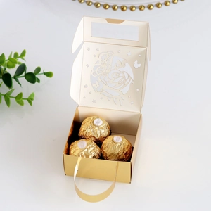 Close-up of golden laser-cut butterfly gift box featuring hollow stars and elegant handles